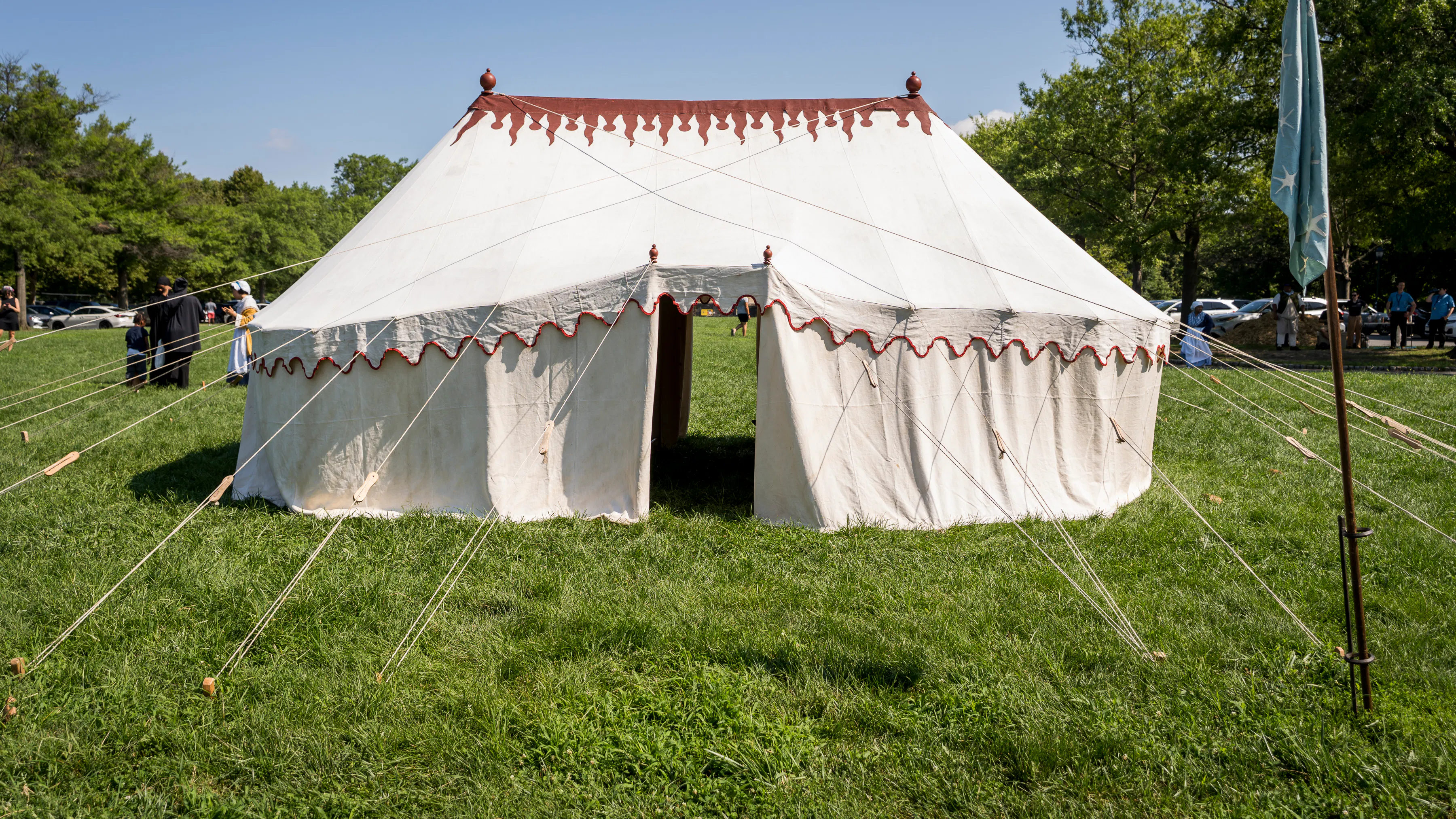 This image shows the handsewn replica linen tent with a silk replica commander in chief standard out front at FDR Park.