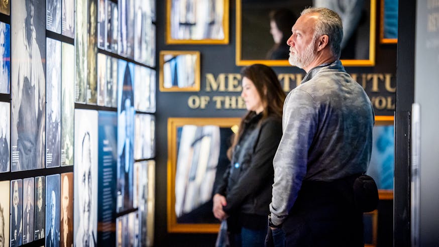 A visitor views the photographs on the Revolutionary Generation wall in the core exhibition.