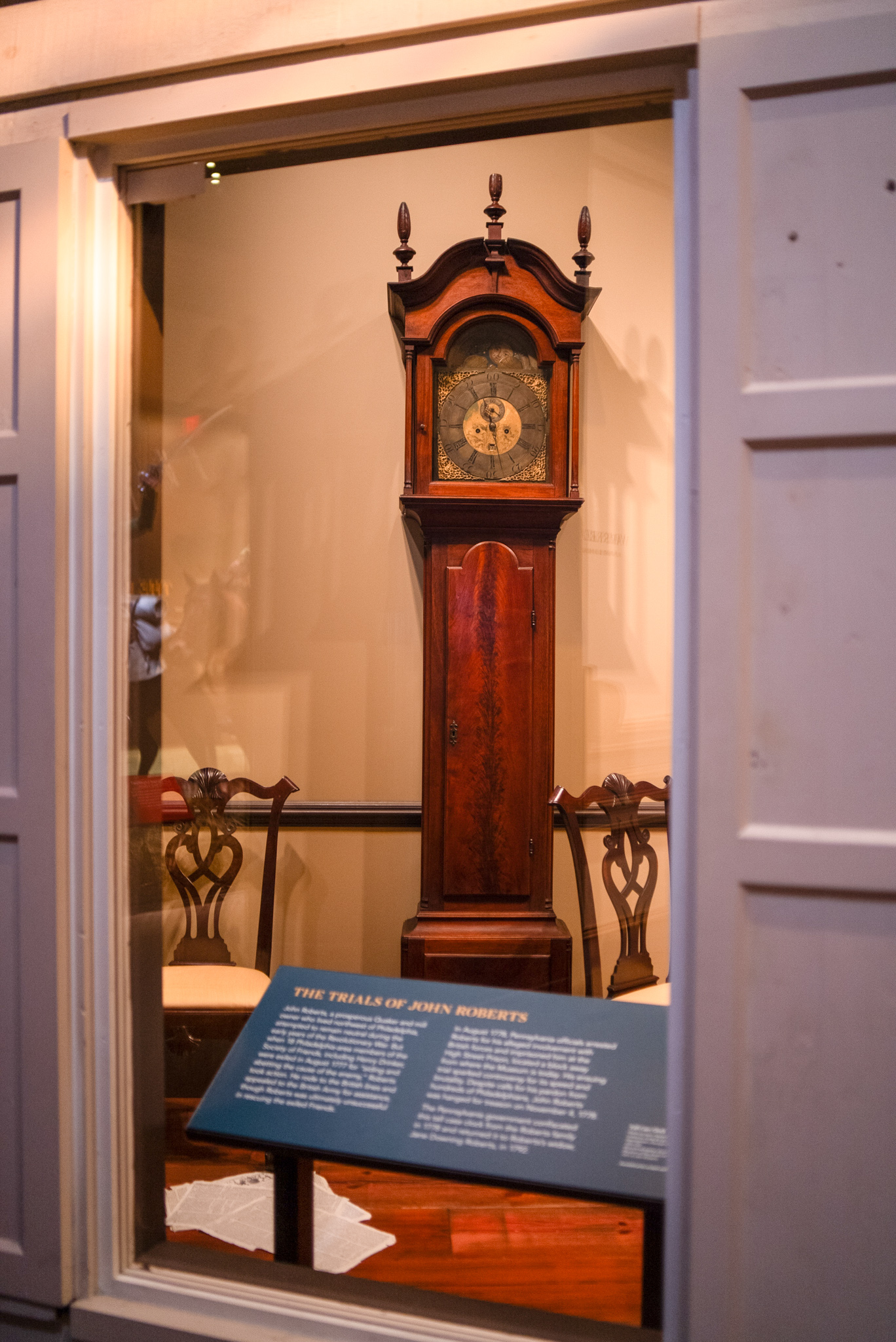 A wooden clock with an intricately designed face
