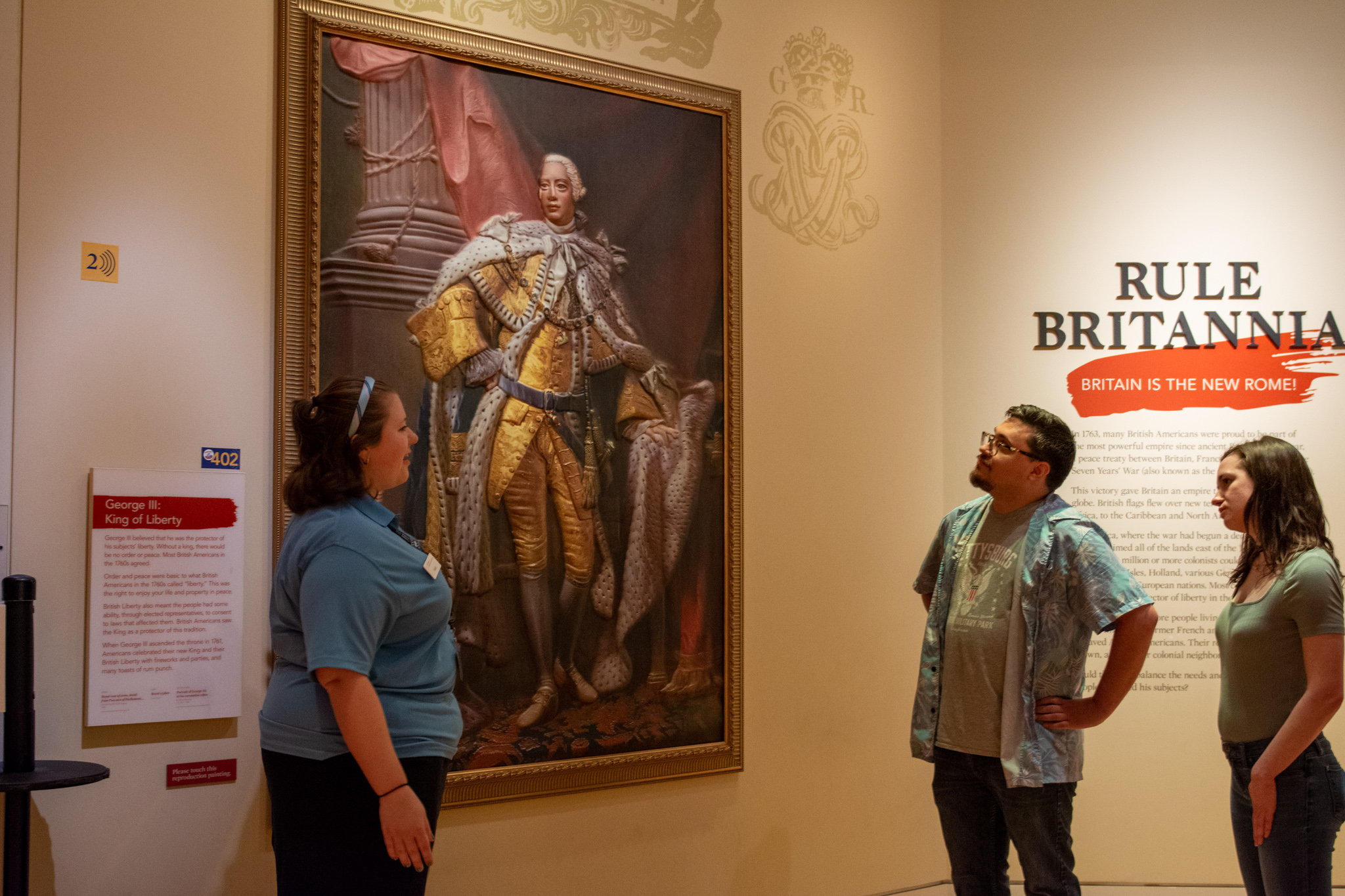 Docent shows visitors 3D portrait of King George III