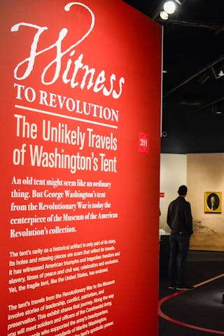Introductory wall panel in the Witness to Revolution special exhibit with white text on a red background.